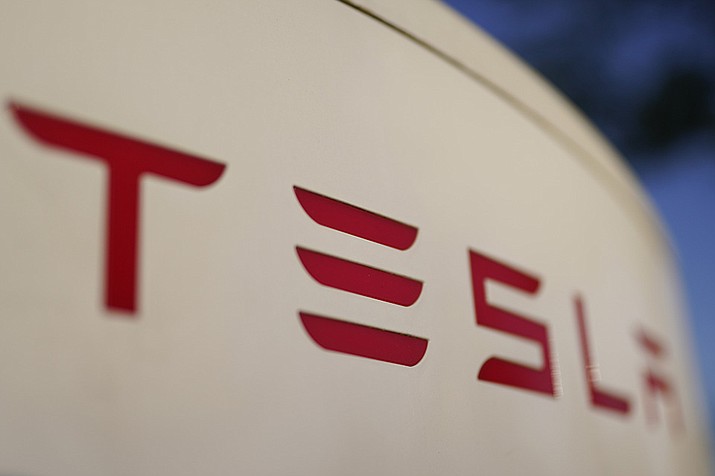 The logo for the Tesla Supercharger station is seen in Buford, Ga, April 22, 2021. Tesla is recalling nearly 579,000 vehicles in the U.S. because sounds played over an external speaker can obscure audible warnings for pedestrians. The recall is the fourth made public in the last two weeks as U.S. safety regulators increase scrutiny of the nation’s largest electric vehicle maker. ( Chris Carlson, AP File)