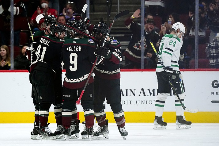 Arizona Coyotes center Nick Schmaltz (8) celebrates his goal against the Dallas Stars with Coyotes left wing Lawson Crouse, back left, Coyotes right wing Phil Kessel (81), Coyotes right wing Clayton Keller (9) and Coyotes defenseman Shayne Gostisbehere, second from right, as Stars center Roope Hintz (24) skates away during the second period of a game Sunday, Feb. 20, 2022, in Glendale. (Ross D. Franklin/AP)