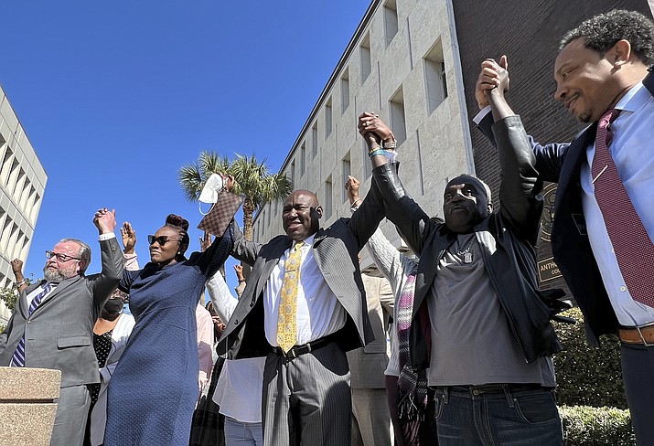 The family and attorneys of Ahmaud Arbery raise their arms in victory outside the federal courthouse in Brunswick, Ga., after all three men involved in his killing were found guilty of hate crimes, Tuesday, Feb. 22, 2022. Greg McMichael, Travis McMichael and William “Roddie” Bryan were found guilty of violating Arbery’s civil rights and targeting him because he was Black. (Lewis M. Levine/AP)
