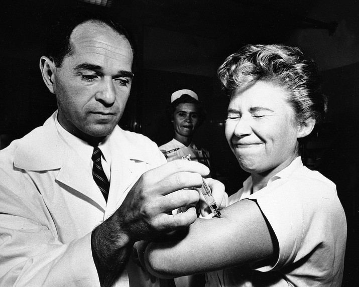 Dr. Joseph Ballinger giving Marjorie Hill, a nurse at Montefiore Hospital in New York, the first Asian flu vaccine shot to be administered in New York on Aug. 16, 1957. (AP Photo/File)