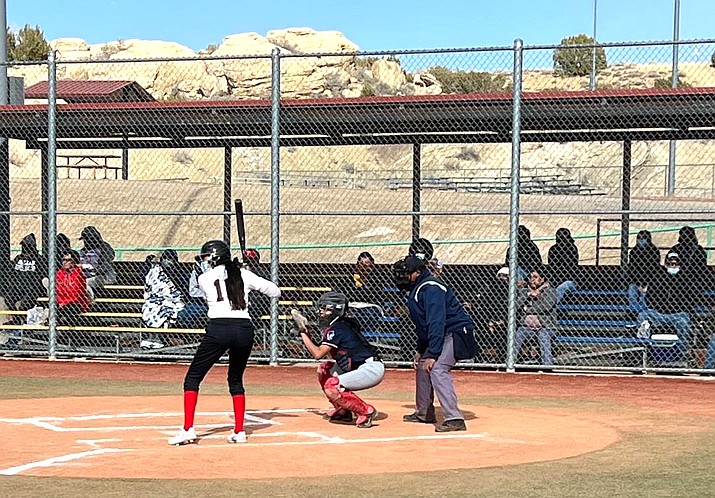 Lady Cardinals starting pitcher Jenna Ross (21) prepares to hit during a recent softball game against Red Mesa. On deck is infielder Gabriella Simpson (22). St. Michaels won the 1A North conference game, 12-4. (Photo/SMIS)