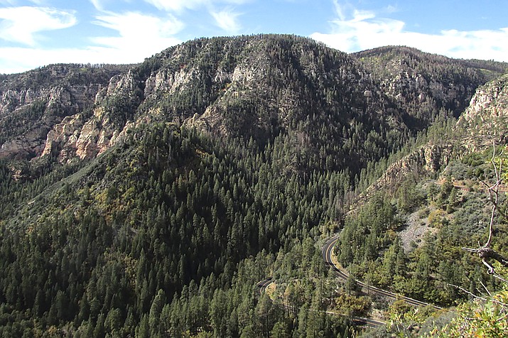 Switchbacks of U.S. 89A, a scenic highway in north-central Arizona, hug a cliffside of Oak Creek Canyon as it descends between Flagstaff and Sedona, Ariz., on Oct. 18, 2014. Several projects planned along one of Arizona's most scenic highways will include a safety tune-up and structural improvements but also is expected to inconvenience area residents and travelers using the two-lane route in the steep-sided canyon. The work planned by the Arizona Department of Transportation for U.S. 89A through Oak Creek Canyon north of Sedona and south of Flagstaff will begin this spring and run well into 2023. (AP Photo/Paul Davenport)