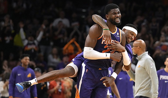 Phoenix Suns center Deandre Ayton (22) and forward Torrey Craig (0) react after a score against the Los Angeles Lakers during the second half of an NBA basketball game Tuesday, April 5, 2022, in Phoenix. The Suns won 121-110. (AP Photo/Rick Scuteri)