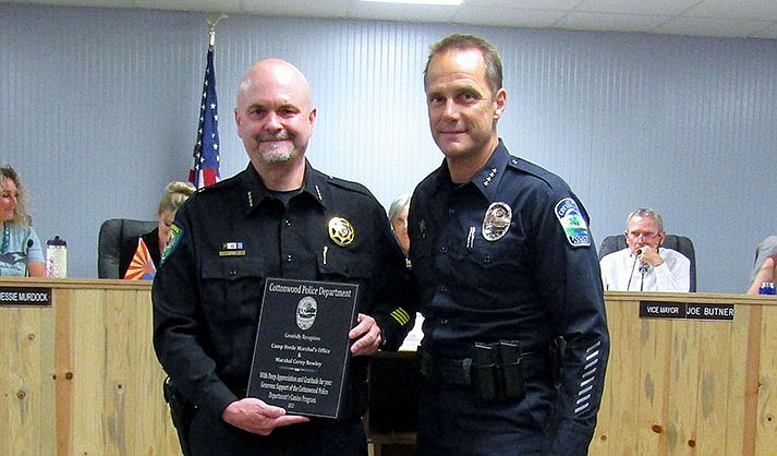 Cottonwood Police Chief Stephen Gesell (right) presented a token of gratitude to Camp Verde Marshal Corey Rowley for loaning the town a K-9 unit vehicle after theirs was lost during a rescue effort in July of 2021.