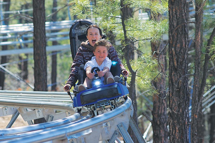 Williams residents Ashlynn Kennelly and Karsen Smith enjoy a ride at Canyon Coaster Adventure Park’s opening day April 8. (Wendy Howell/WGCN)