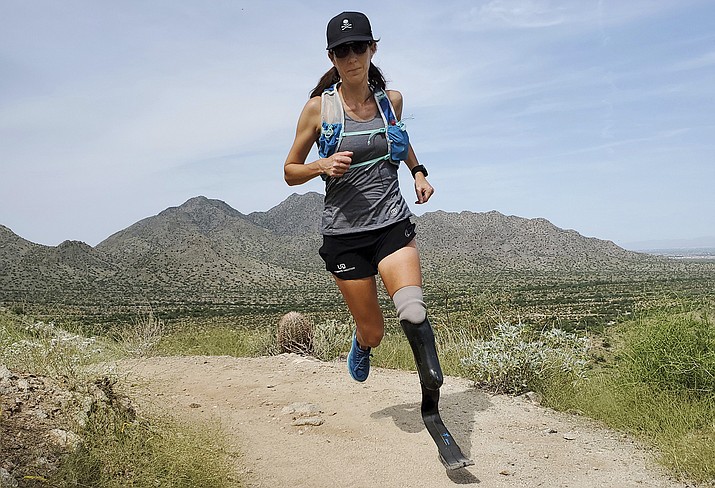 Marathoner Jacky Hunt-Broersma trains on Aug. 28, 2021 at San Tan Mountain Regional Park, in San Tan Valley, Az. Hunt-Broersma lost her left leg below the knee to a rare form of cancer, but she hasn't let that stop her and is trying to cover the classic 26.2-mile marathon distance at least 102 times in 102 days, which would set a new world record. The Boston Marathon on April 18 is expected to be No. 92 in her streak. (Edwin Broersma via AP)