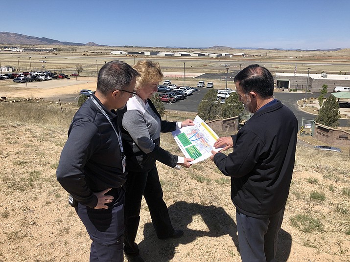 Prescott Regional Airport Operations Supervisor Jason Kadah, left, Airport Director Robin Sobotta, center, and Parker Northrup, chair of the Flight Department at Embry-Riddle Aeronautical University’s College of Aviation, right, look at the plans for Embry-Riddle’s Strategic Academic Flight Education (SAFE) complex, planned on the airport grounds. (Cindy Barks/Courier)