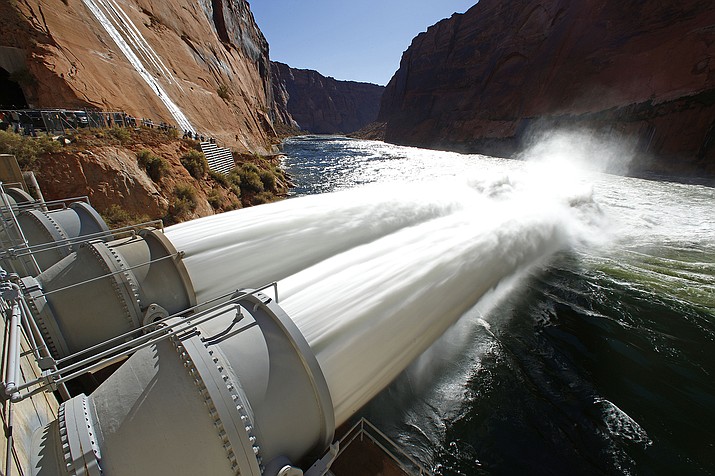 A high-flow release of water flows into the Colorado River from bypass tubes at Glen Canyon Dam in Page, Arizona in 2012.  (Rob Schumacher/The Arizona Republic via AP, File)