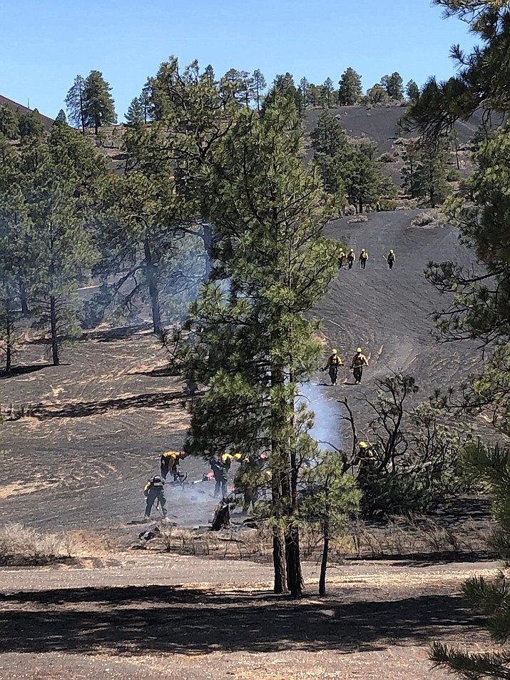 Photo from the frontline Monday, April 25. Fire technicians and pilots work to put out spots around the Tunnel Fire utilizing large capacity "heliwells' used as helicopter dip tanks. (Photo/Coconino National Forest)