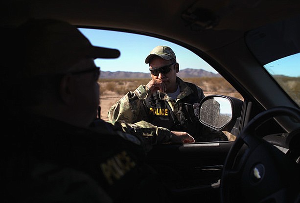A Shadow Wolf stands next to a vehicle during a patrol in Southern Arizona. The unit was recently reclassified as special agents within U.S. Immigration and Customs Enforcement. (Photo/ICE, U.S. Immigration and Custom Service)