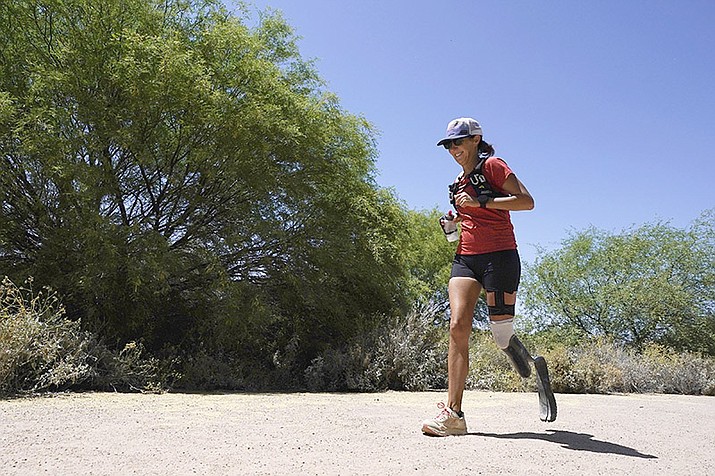 Jacky Hunt-Broersma runs her 102nd marathon in 102 days, this one at Veterans Oasis Park, Thursday, April 28, 2022, in Chandler, Ariz. (Ross D. Franklin/AP)