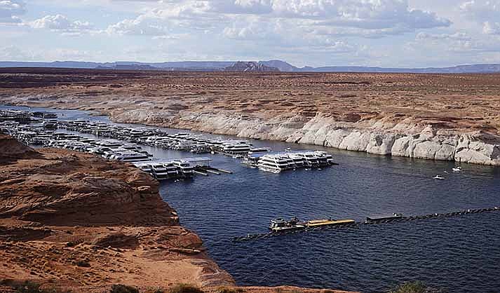 A white band of newly exposed rock is shown along the canyon walls at Lake Powell at Antelope Point Marina near Page, showing the difference in water levels. (AP Photo/Rick Bowmer, File)