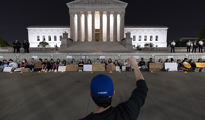 A crowd of people gather outside the Supreme Court early Tuesday, May 3, 2022, in Washington.(AP Photo/Alex Brandon)