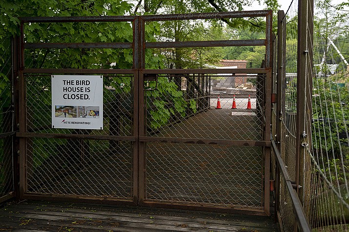 The Bird House, which is currently closed due to construction, is seen behind locked gates at the Smithsonian's National Zoo, Wednesday, May 4, 2022, in Washington. Zookeepers at the National Zoo made a macabre discovery Monday morning, when they entered the outdoor enclosure that housed 74 flamingos. A wild fox from neighboring Rock Creek Park had apparently chewed a hole in the metal mesh fencing overnight and wreaked havoc, killing 25 flamingos and injuring three others. One Northern pintail duck was also killed. (Jacquelyn Martin/AP)
