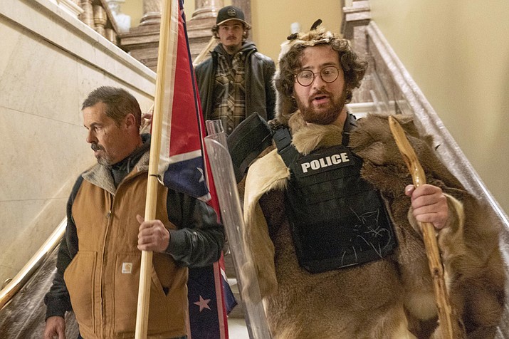Supporters of President Donald Trump, including Aaron Mostofsky, right, who is identified in his arrest warrant, walk down the stairs outside the Senate Chamber in the U.S. Capitol, in Washington, Jan. 6, 2021. (Manuel Balce Ceneta/AP, File)