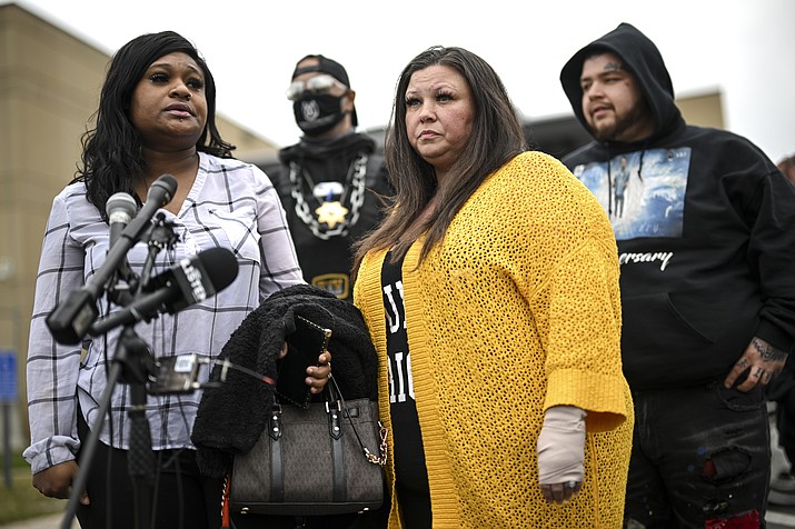 Katie Wright, center, stands beside activist Toshira Garraway and her son, Damik Bryant, during a news conference Thursday, May 5, 2022 outside the Brooklyn Center Police Station in Brooklyn Center, Minn. Katie Wright, the mother of Daunte Wright, said she was injured while she was briefly detained by one of the same department’s officers after she stopped to record an arrest of a person during a traffic stop. (Aaron Lavinsky/Star Tribune via AP)