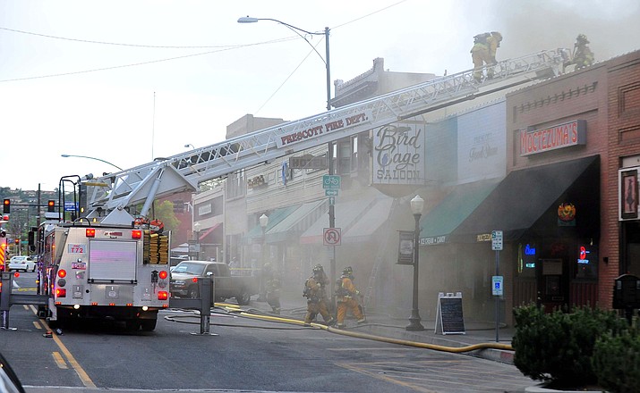 Firefighters from around the area battle the blaze on Whiskey Row that is centered near the Bird Cage Saloon Tuesday night, May 8, 2012, in downtown Prescott. (Matt Hinshaw/Courier file)