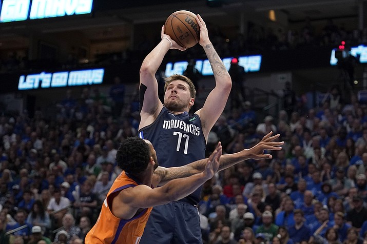 Phoenix Suns guard Cameron Payne defends as Dallas Mavericks guard Luka Doncic (77) takes a shot in the second half of Game 4 of a second-round playoff series, Sunday, May 8, 2022, in Dallas. (Tony Gutierrez/AP)