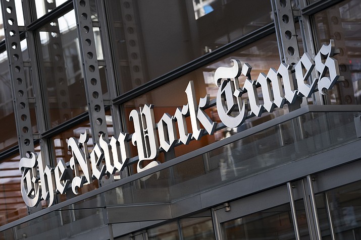 A sign for The New York Times hangs above the entrance to its building, Thursday, May 6, 2021 in New York. The New York Times moved swiftly to change the word fetus, Monday's answer to its daily Wordle puzzle, out of fear that it would be seen as some sort of commentary on the debate over abortion rights. The game, which became a sensation late last year and was bought by The Times in January, gives users six tries to guess a different five-letter word each day. (Mark Lennihan/AP, File)