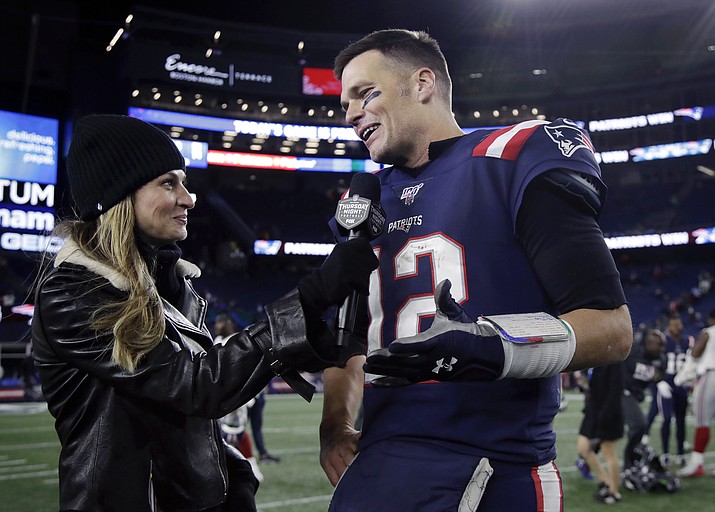 Fox Sports television sideline broadcast reporter Erin Andrews, left, interviews then-New England Patriots quarterback Tom Brady at midfield after an NFL football game between the Patriots and the New York Giants, Thursday, Oct. 10, 2019, in Foxborough, Mass. Seven-time Super Bowl champion Tom Brady will join Fox sports as its lead football analyst once his playing career ends, the network said on Tuesday, May 10, 2022. When that actually happens is unclear, since Brady recently renounced his announced retirement and said he plans to continue playing for the Tampa Bay Bucs. (Elise Amendola/AP, File)