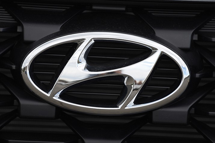 The Hyundai logo shines off the grille of an unsold vehicle at a Hyundai dealership Sunday, Sept. 12, 2021, in Littleton, Colo. Hyundai is recalling more than 215,000 midsize cars in the U.S., Wednesday, May 11, 2022, most for a second time _ because fuel hoses can leak in the engine compartment and cause fires. The recall covers certain 2013 and 2014 Sonata sedans, many of which were recalled for the same problem in 2020. (David Zalubowski/AP, File)