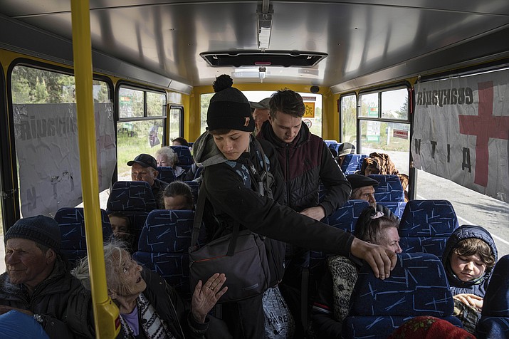 People ride in the bus during evacuation near Lyman, Ukraine, Wednesday, May 11, 2022. (Evgeniy Maloletka/AP)
