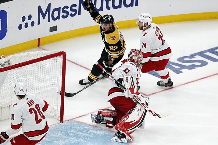 Boston Bruins' Brad Marchand (63) celebrates after scoring on Carolina Hurricanes goalie Antti Raanta (32) during the second period in Game 6 of an NHL hockey Stanley Cup first-round playoff series Thursday, May 12, 2022, in Boston. (AP Photo/Michael Dwyer/AP)