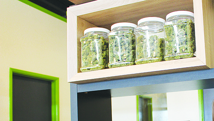Arizona’s public health agency has awarded more than two dozen social equity dispensary licenses under the state’s voter-approved law legalizing recreational marijuana. Jars of marijuana are pictured on a dispensary shelf in this file photo. (Miner file photo)