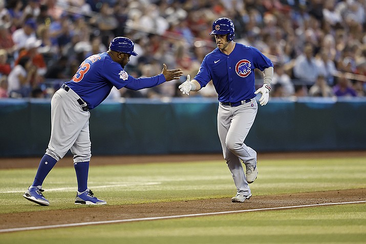 Chicago Cubs' Yan Gomes (7) is greeted by third base coach third base coach Willie Harris as Gomes heads for home on a solo home run during the fourth inning of the team's baseball game against the Arizona Diamondbacks on Saturday, May 14, 2022, in Phoenix. (Chris Coduto/AP)