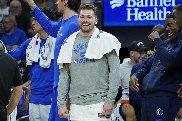 Dallas Mavericks guard Luka Doncic smiles on the bench during the second half of Game 7 of a Western Conference playoff semifinal against the Phoenix Suns, Sunday, May 15, 2022, in Phoenix. The Mavericks defeated the Suns 123-90. (Matt York/AP)