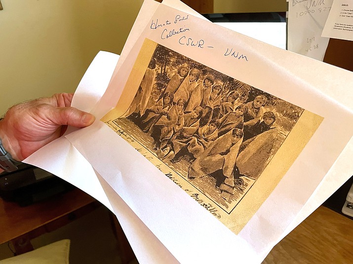 Adjunct history professor and research associate Larry Larrichio holds a copy of a late 19th century photograph of pupils at an Indigenous boarding school in Santa Fe during an interview in Albuquerque, New Mexico. The U.S. Interior Department released a report May 11, that uncovers the truth about the federal government's past oversight of Native American boarding schools. (AP Photo/Susan Montoya Bryan, File)