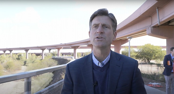 U.S. Rep. Greg Stanton, D-Phoenix, talks with reporters near Loop 202 in Tempe on Feb. 24, 2022, about a bill he has sponsored to fund the use of drones to inspect infrastructure. (Faith Abercrombie/Cronkite News)