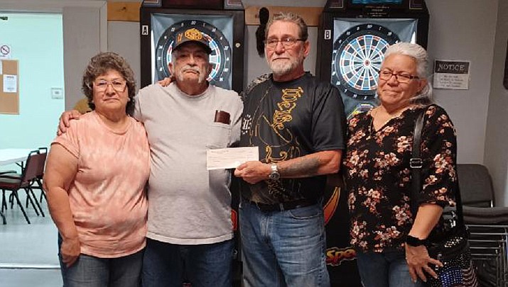 The VFW Post 10386 dart league donated $1,550 to the Fireball Foundation. From left are Irene and Russ Adkins of the dart league and Wendell and Gaby Jones of the foundation. (Courtesy photo)