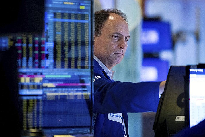In this photo provided by the New York Stock Exchange, trader James Conti works on the floor, Friday, May 20, 2022. The stock market clawed back from a midday drop Friday after coming to the edge of its first bear market since the beginning of the pandemic. (Allie Joseph/New York Stock Exchange via AP)
