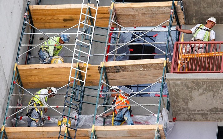 Near-record low jobless rates have left employers scrambling to fill job vacancies, which has Arizona businesses welcoming the federal government’s decision to add another 35,000 H-2B visas for temporary guest workers this year, after the initial allotment were snapped up. Here, construction crews work on a building in downtown Phoenix in this 2018 file photo. (Nicole Neri/Cronkite News, file)