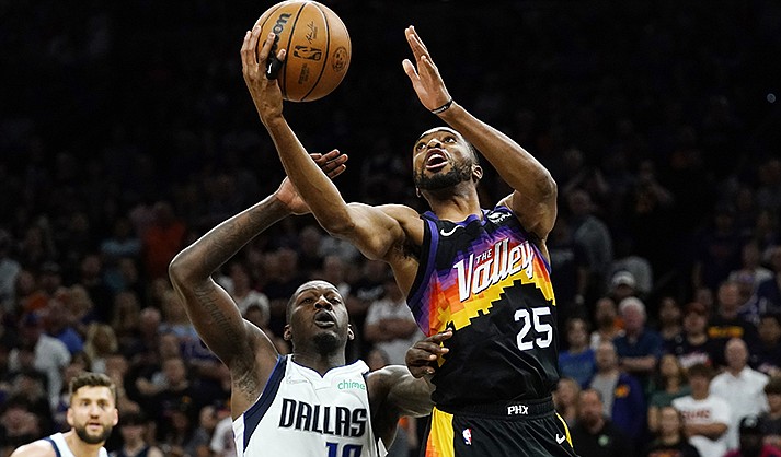 Phoenix Suns forward Mikal Bridges (25) drives past Dallas Mavericks forward Dorian Finney-Smith (10) to score during the playoffs in Phoenix. (AP Photo/Ross D. Franklin)
