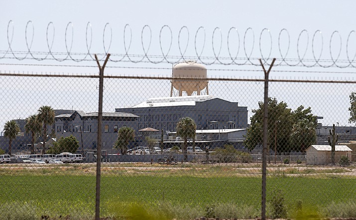 In this July 23, 2014, photo, a fence surrounds the state prison in Florence, Ariz. Arizona legislators are moving to tighten the state's law on capital punishment by eliminating three of the 14 so-called "aggravating factors" than can be the basis for imposing a death sentencing. (AP Photo/File)