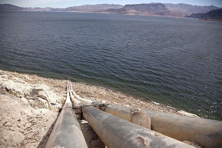 Pipes extend into Lake Mead well above the high water mark near Boulder City, Nevada on March 23, 2012. The sight of fountains, swimming pools, gardens and golf courses in Western cities like Phoenix, Los Angeles, Las Vegas, San Diego and Albuquerque can seem jarring with drought and climate change tightening their grip on the region. But Western water experts say they aren’t necessarily cause for concern. Many Western cities over the past three decades have diversified their water sources, boosted local supplies, and use water more efficiently now than in the past. (AP Photo/Julie Jacobson, File)