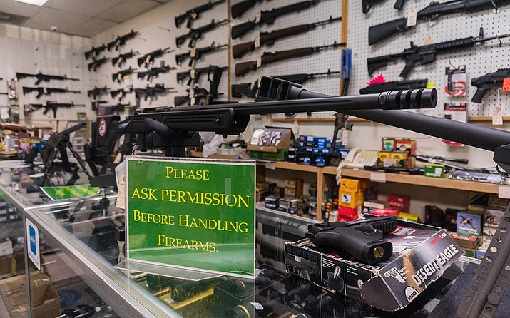 Firearms on display at Legendary Guns store in Phoenix in 2018, when there were 377,838 firearm background checks in Arizona. By 2020, that number had jumped to 665,458 and it has since remained well above previous years. Now, analysts say there could be another surge in buying in response to the recent spate of mass shootings in the U.S. (Daria Kadovik/Cronkite News)