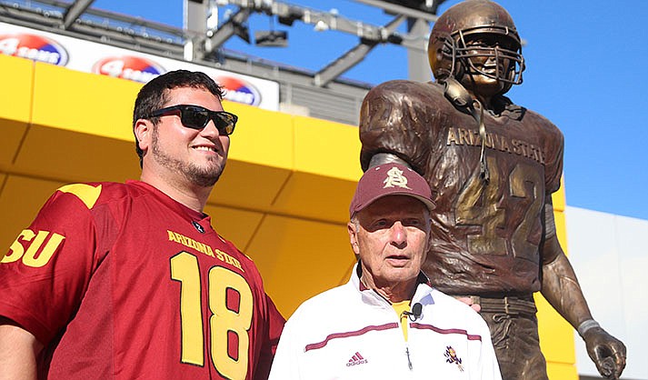 Arizona State has sought to honor Pat Tillman in many ways. Here, former ASU quarterback Fran Urban stands next to the Pat Tillman statue with his grandson. (File photo by Edwin Rodriguez/Cronkite News)