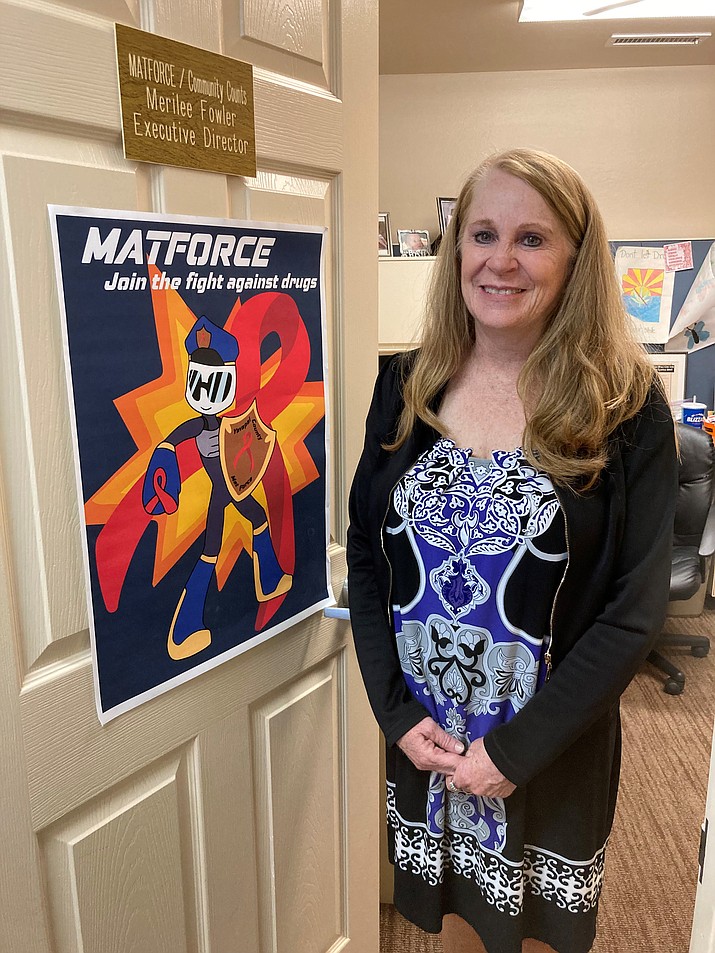 MatForce Executive Director Merliee Fowler stands next to a 2022 drug prevention poster crafted by Camp Verde High School senior Corynn Helgeson. Helgeson won the poster contest’s new Executive Choice Award that Fowler posted on her Prescott Valley office door. (Nanci Hutson/Courier)