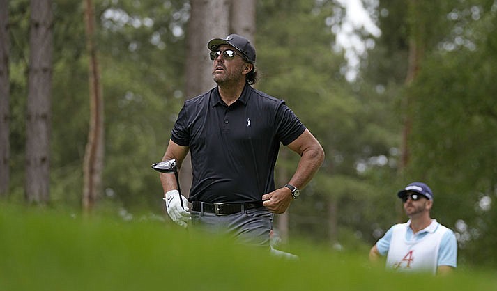Phil Mickelson of the United States watches the flight of his ball after playing off the 4th tee during the first round of the inaugural LIV Golf Invitational at the Centurion Club in St. Albans, England, Thursday, June 9, 2022. (AP Photo/Alastair Grant)