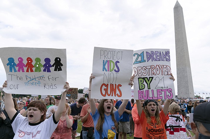 Protesters hold signs in the second March for Our Lives rally in support of gun control in front of the Washington Monument, Saturday, June 11, 2022, in Washington. The rally is a successor to the 2018 march organized by student protesters after the mass shooting at a high school in Parkland, Fla. (Jose Luis Magana/AP)