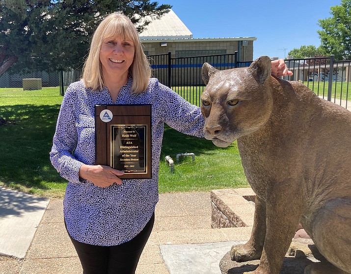 Chino Valley High School Principal Heidi Wolf with her state award from the Arizona School Administrators standing next to the Chino Valley Cougar mascot outside the front lobby of the high school. (Nanci Hutson/Courier)
