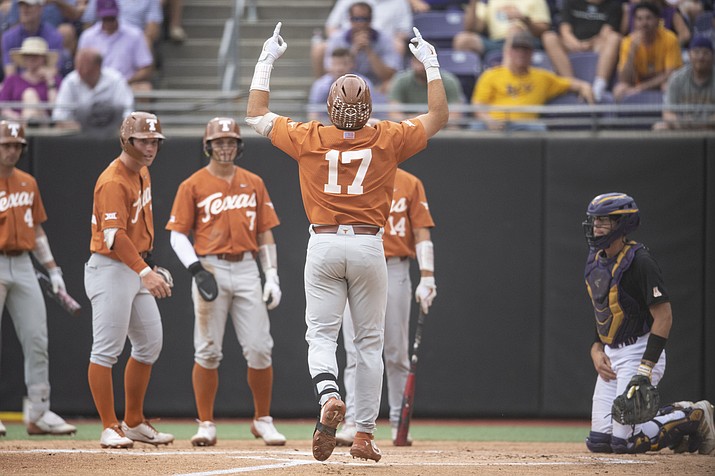Texas' Ivan Melendez gestures at home plate after hitting a three-run home run during the first inning of an NCAA college super regional game against East Carolina on Sunday, June 12, 2022, in Greenville, N.C. (Matt Kelley/AP)