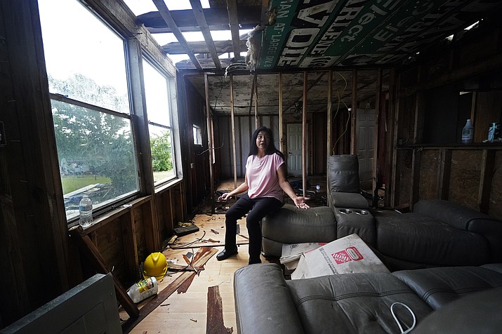 Louise Billiot, a member of the United Houma Nation Indian tribe, talks inside the home of her friend Irene Verdin, which was heavily damaged from Hurricane Ida nine months before, along Bayou Pointe-au-Chien, La., Thursday, May 26, 2022. (Gerald Herbert/AP)