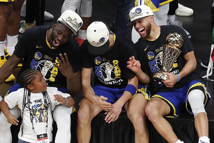 Golden State Warriors guard Stephen Curry, right, forward Draymond Green, left, and Golden State Warriors guard Klay Thompson celebrate after defeating the Boston Celtics in Game 6 to win the NBA Finals championship, Thursday, June 16, 2022, in Boston. (Michael Dwye/AP)