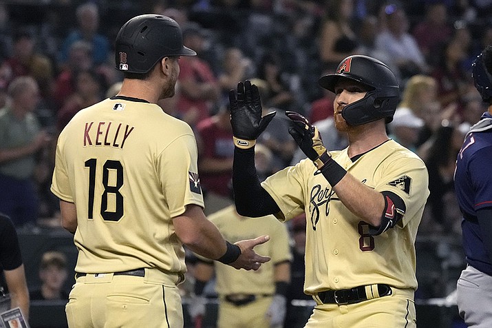 Arizona Diamondbacks' Jordan Luplow celebrates with teammate Carson Kelly (18) after hitting a two-run home run against the Minnesota Twins in the first inning during a baseball game, Friday, June 17, 2022, in Phoenix. (Rick Scuteri/AP)