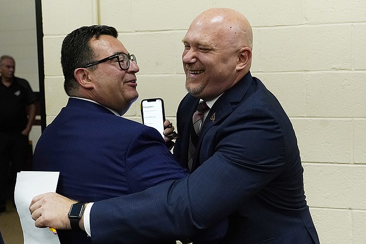 Arizona Coyotes NHL hockey team president and CEO Xavier Gutierrez, left, greets new team head coach Andre Tourigny, right, after a news conference at Gila River Arena Thursday, July 1, 2021, in Glendale. After an eight-hour meeting last week, the Coyotes finally got what they wanted: approval to negotiate with the city of Tempe to build a new arena close to downtown. (Ross D. Franklin, AP File)