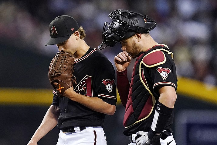 Arizona Diamondbacks catcher Carson Kelly, right, talks with starting pitcher Luke Weaver during the third inning of the team's baseball game against the Minnesota Twins on Saturday, June 18, 2022, in Phoenix. (Ross D. Franklin/AP)